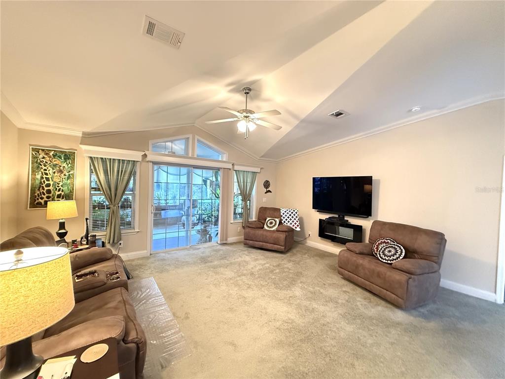 8261 Northeast 118 Terrace Bronson, FL 32621 - Photo 8 of 43 a bedroom with furniture a flat screen tv and a large window