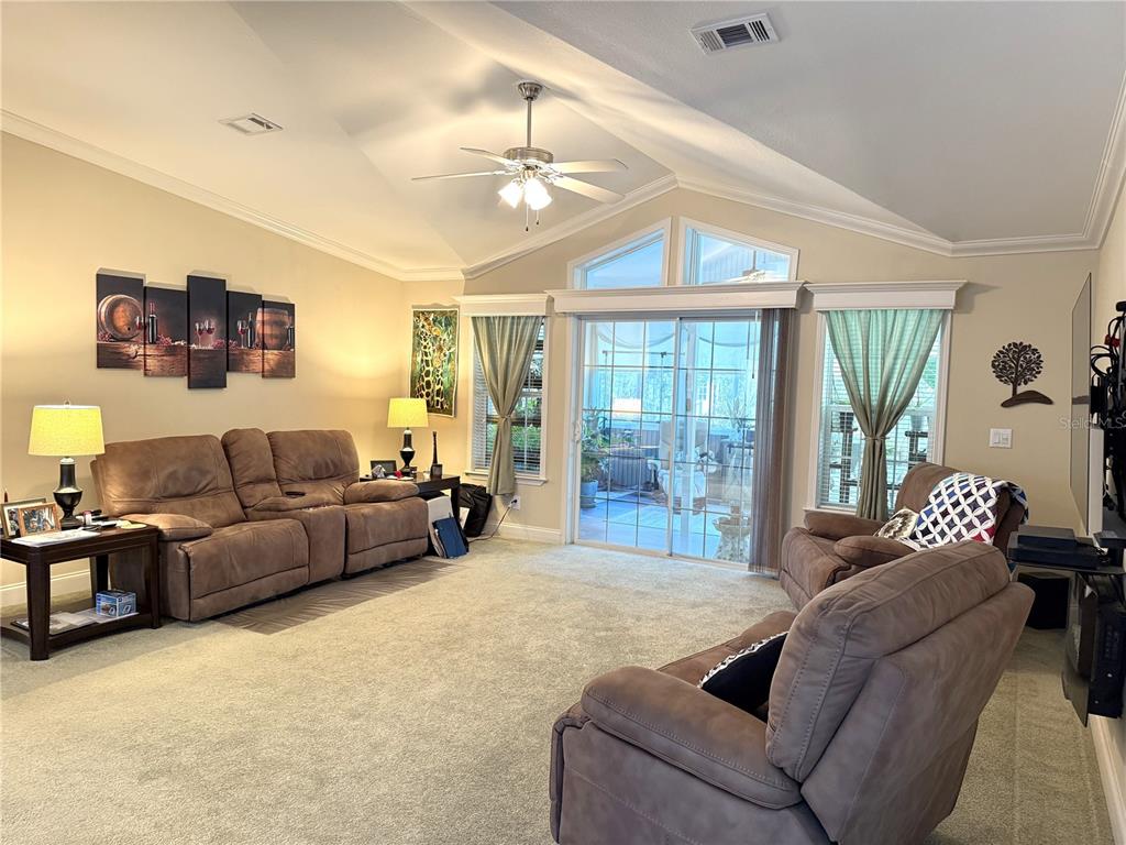 8261 Northeast 118 Terrace Bronson, FL 32621 - Photo 9 of 43 a living room with furniture and a large window