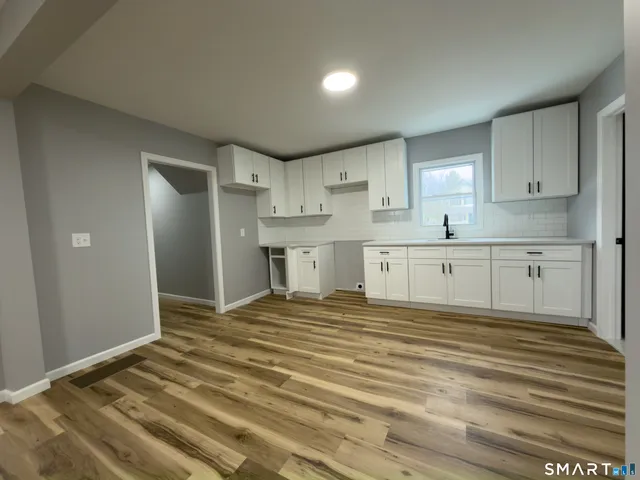 a view of a room with wooden floor and staircase