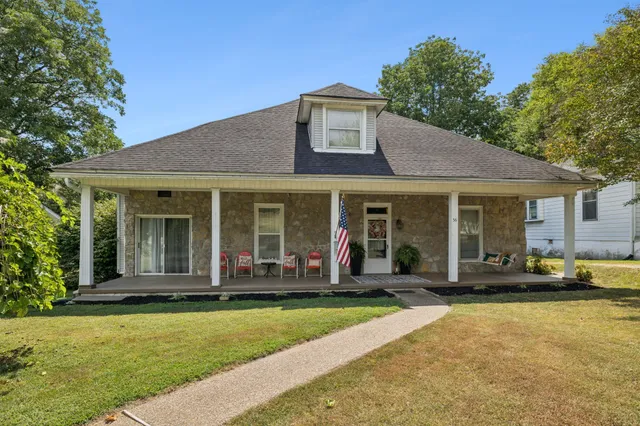 a front view of a house with a yard table and chairs