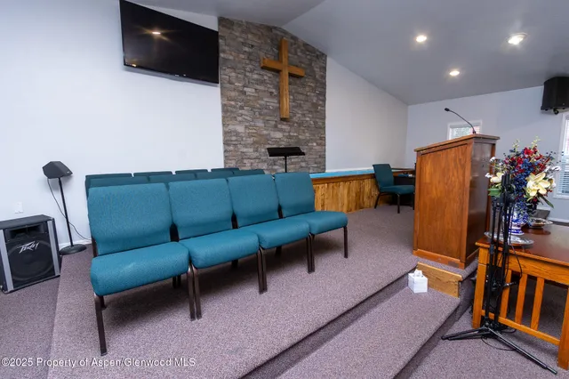 a room with furniture pool table and chairs