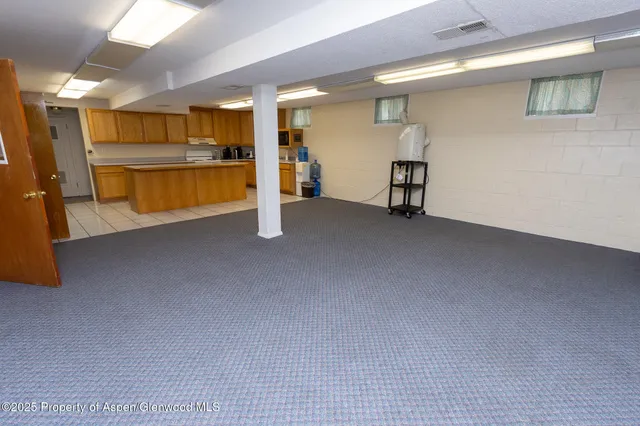 a kitchen with stainless steel appliances a stove a sink and a microwave