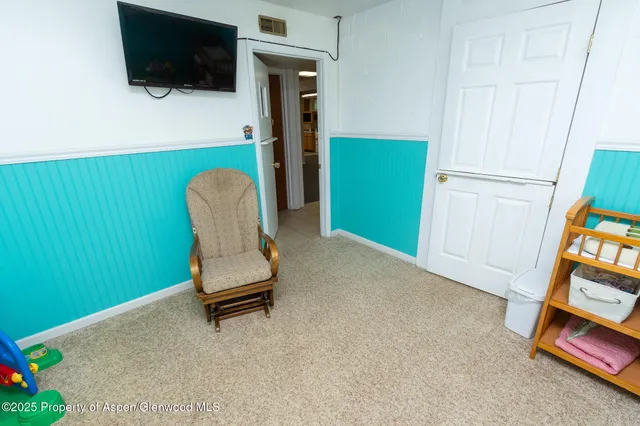 a view of workspace with furniture and mirror