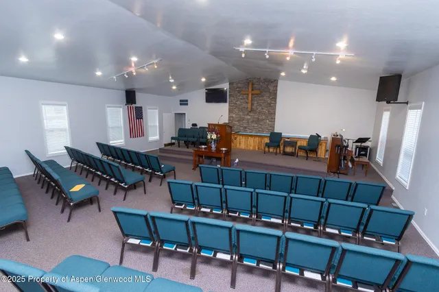 a living room with furniture and a pool table