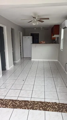 a bathroom with a granite countertop sink and white cabinets