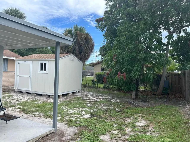 a kitchen with wooden cabinets