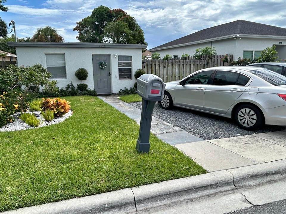 222 Northeast 13th Avenue Boynton Beach, FL 33435 - Photo 6 of 7 a front view of a house with garden