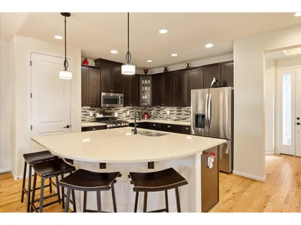 a large kitchen with a table and chairs