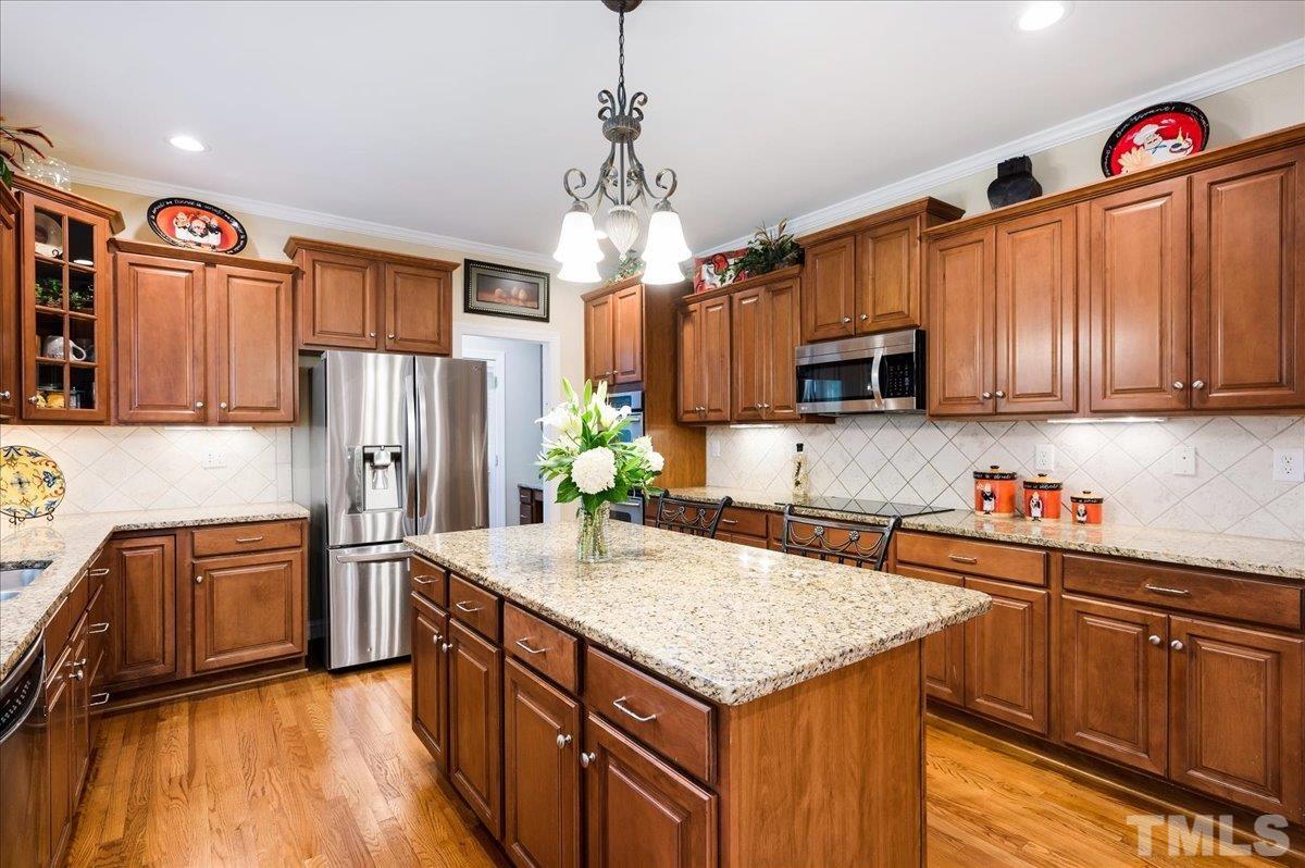 2624 Falls River Avenue Raleigh, NC 27614 - Photo 11 of 38 a kitchen with stainless steel appliances granite countertop a refrigerator a stove top oven and a sink