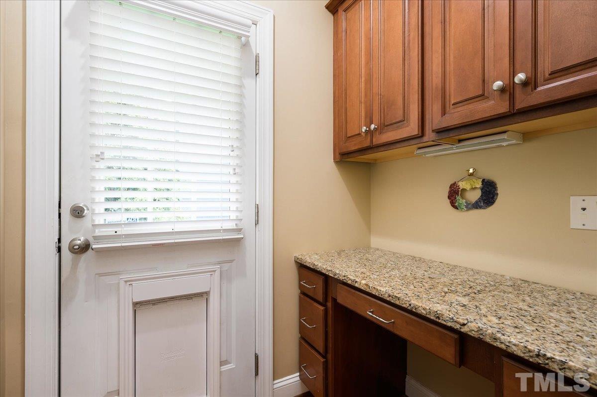 2624 Falls River Avenue Raleigh, NC 27614 - Photo 14 of 38 a kitchen with a granite countertop sink and cabinets