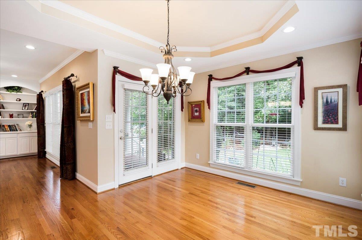 2624 Falls River Avenue Raleigh, NC 27614 - Photo 16 of 38 a view of an empty room with wooden floor and a window