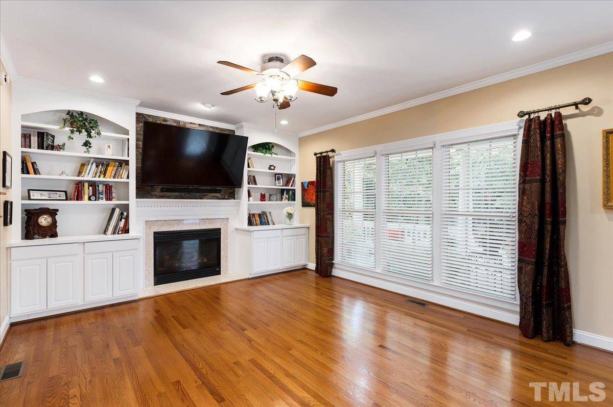 2624 Falls River Avenue Raleigh, NC 27614 - Photo 18 of 38 a view of a livingroom with an empty space and a fireplace