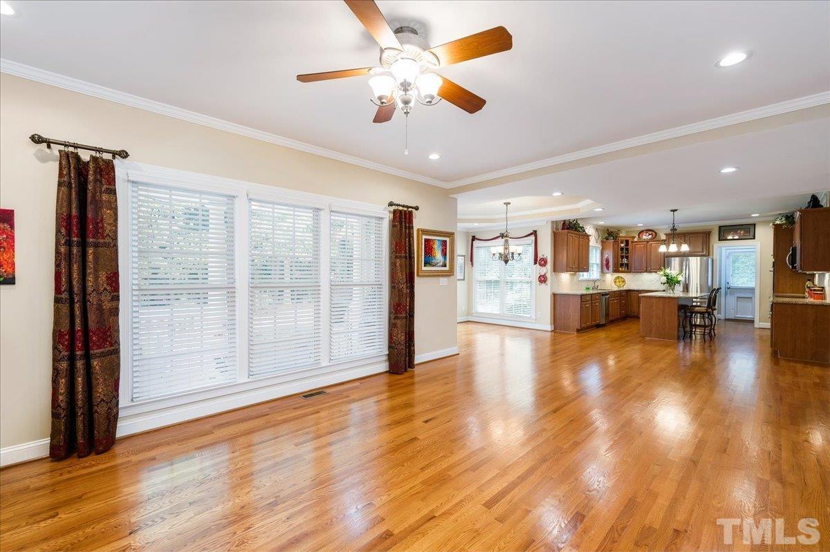 2624 Falls River Avenue Raleigh, NC 27614 - Photo 20 of 38 a view of an empty room and kitchen with ceiling fan