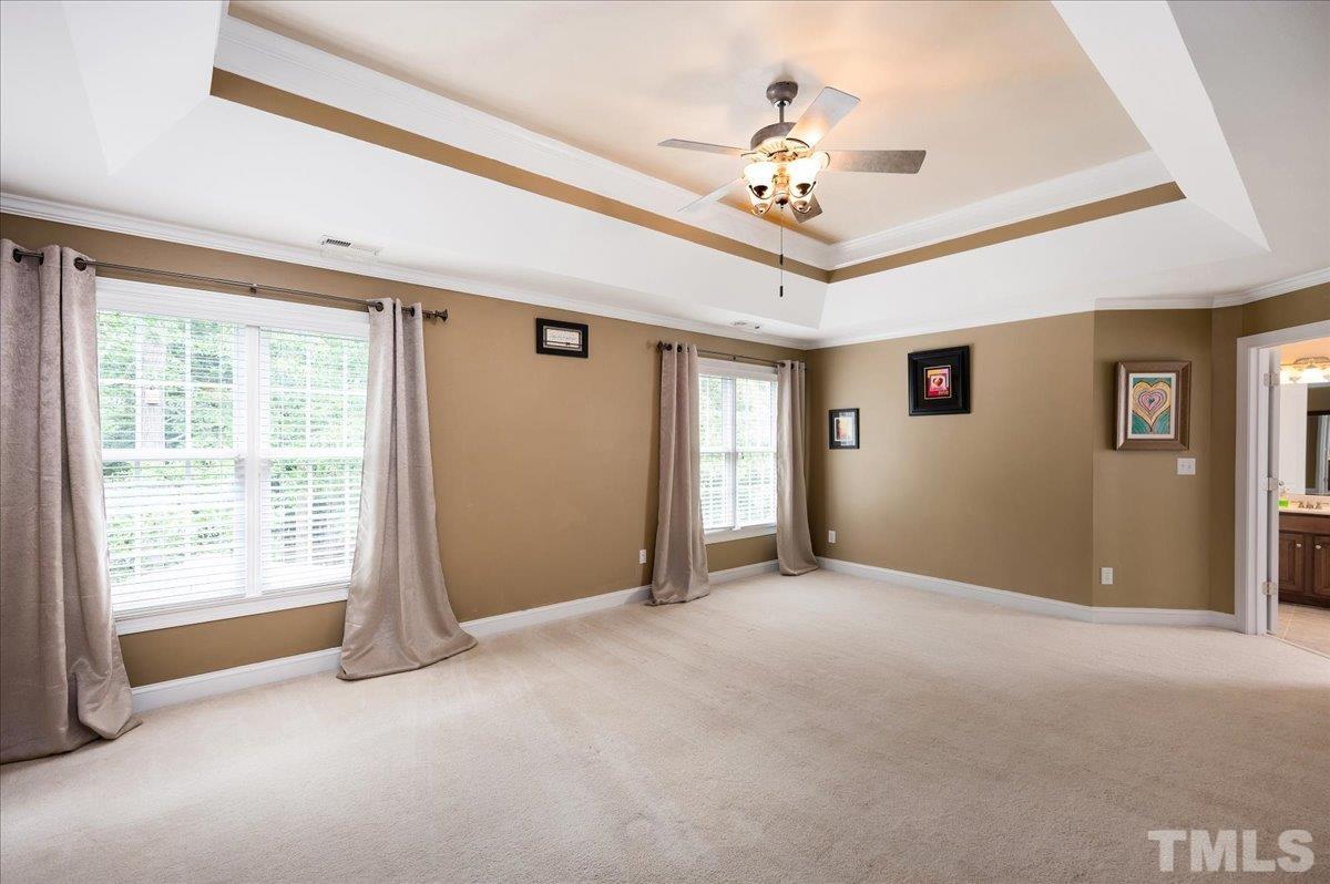 2624 Falls River Avenue Raleigh, NC 27614 - Photo 22 of 38 a view of a livingroom with a chandelier fan and windows