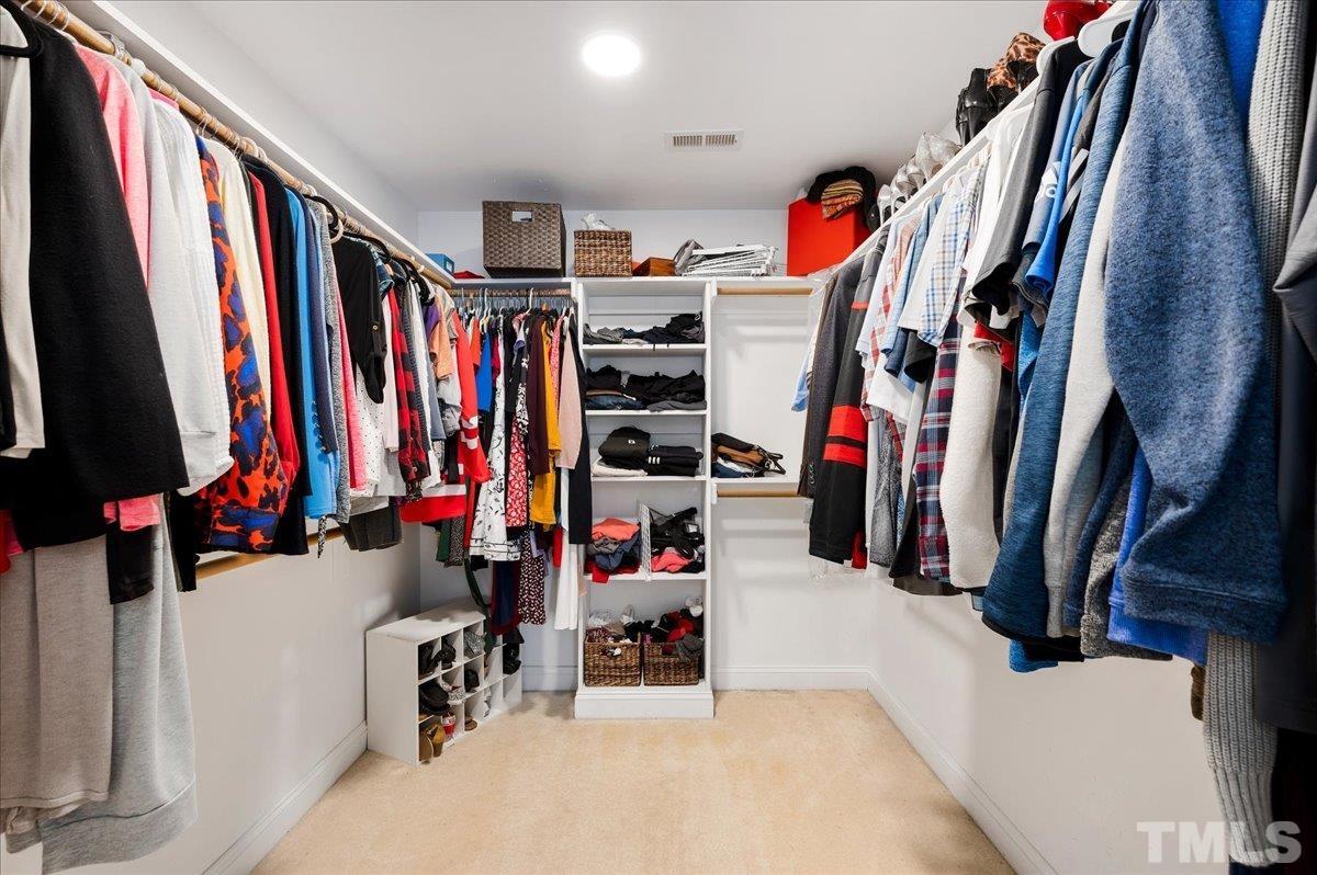 2624 Falls River Avenue Raleigh, NC 27614 - Photo 24 of 38 a view of walk in closet with clothes