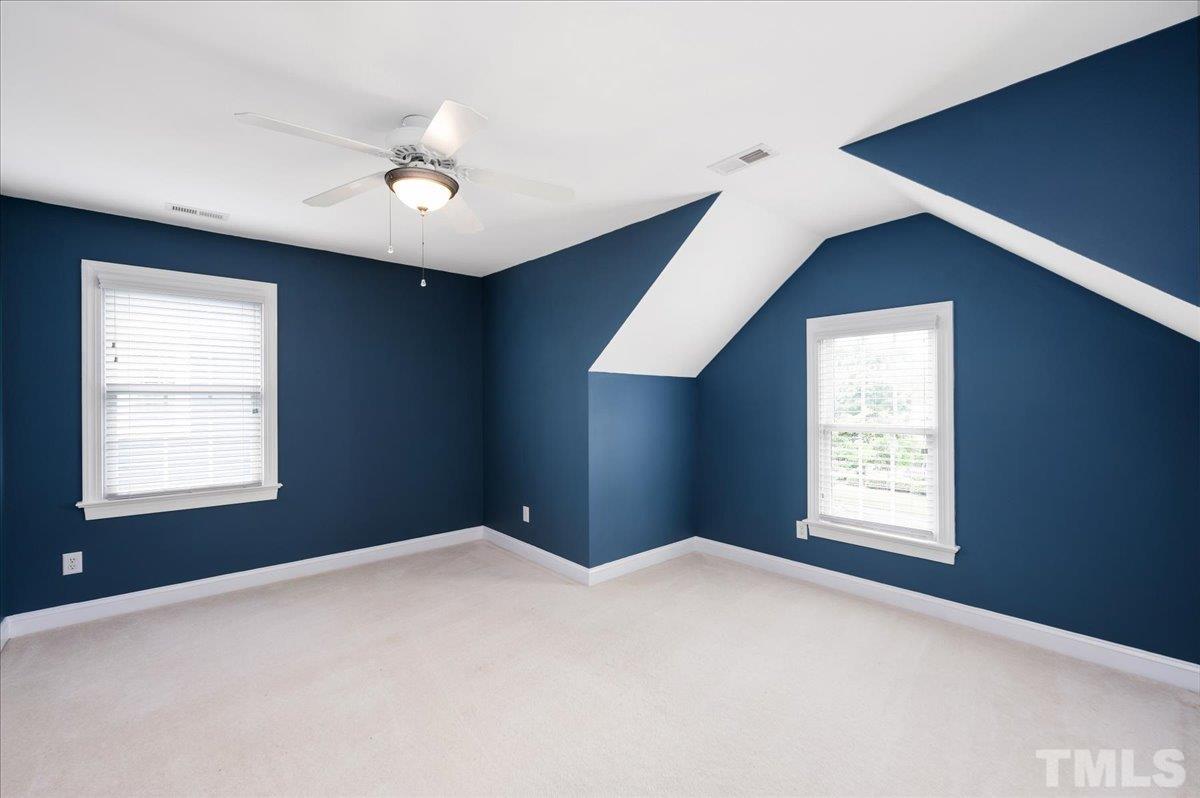 2624 Falls River Avenue Raleigh, NC 27614 - Photo 26 of 38 a bedroom with a large bed and a window