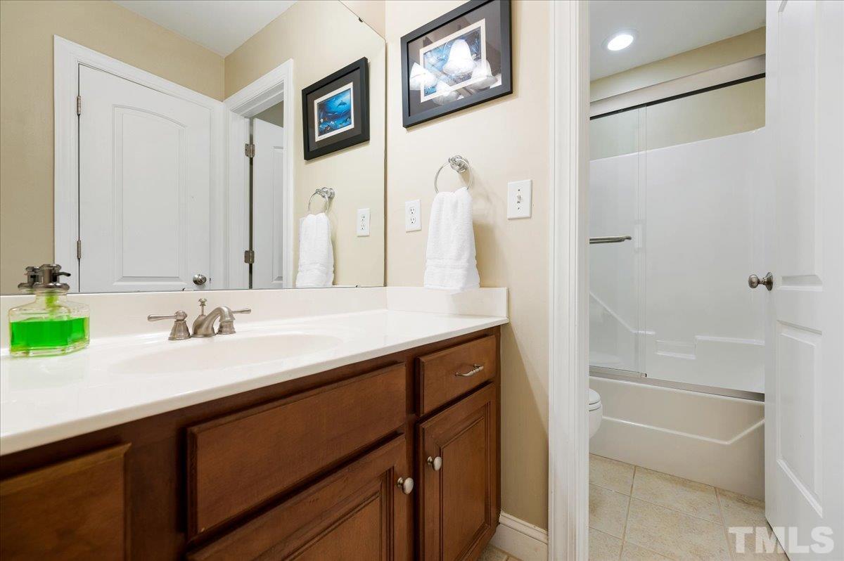 2624 Falls River Avenue Raleigh, NC 27614 - Photo 30 of 38 a bathroom with a sink and a mirror