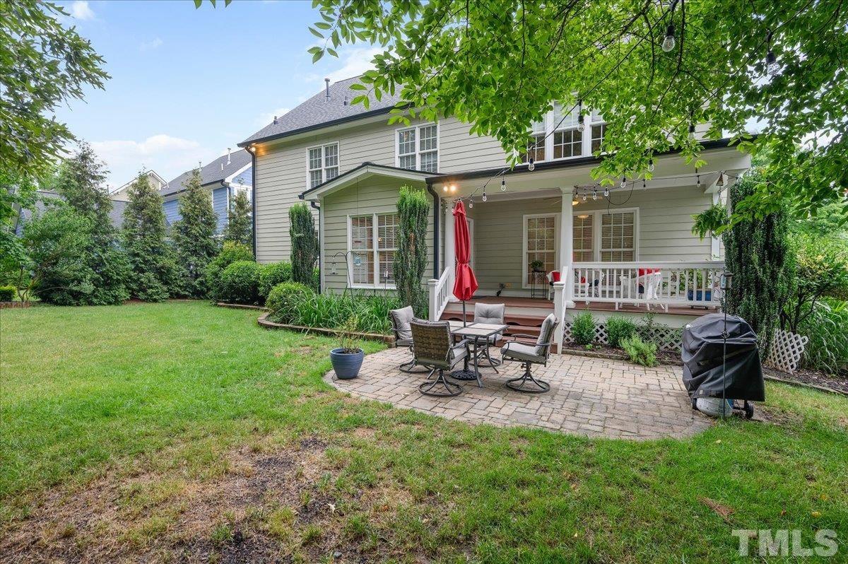 2624 Falls River Avenue Raleigh, NC 27614 - Photo 34 of 38 a view of a chair and table in backyard of the house