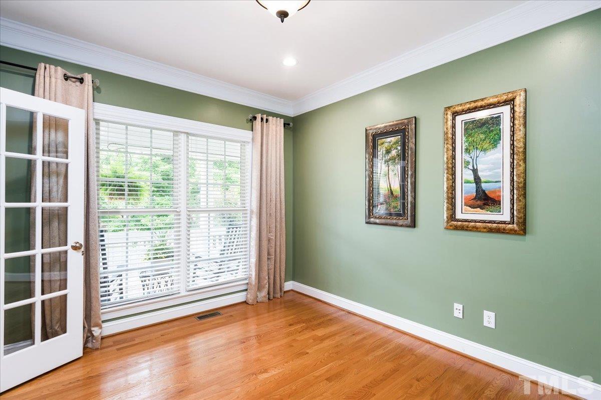 2624 Falls River Avenue Raleigh, NC 27614 - Photo 5 of 38 a view of an empty room with a window and wooden floor