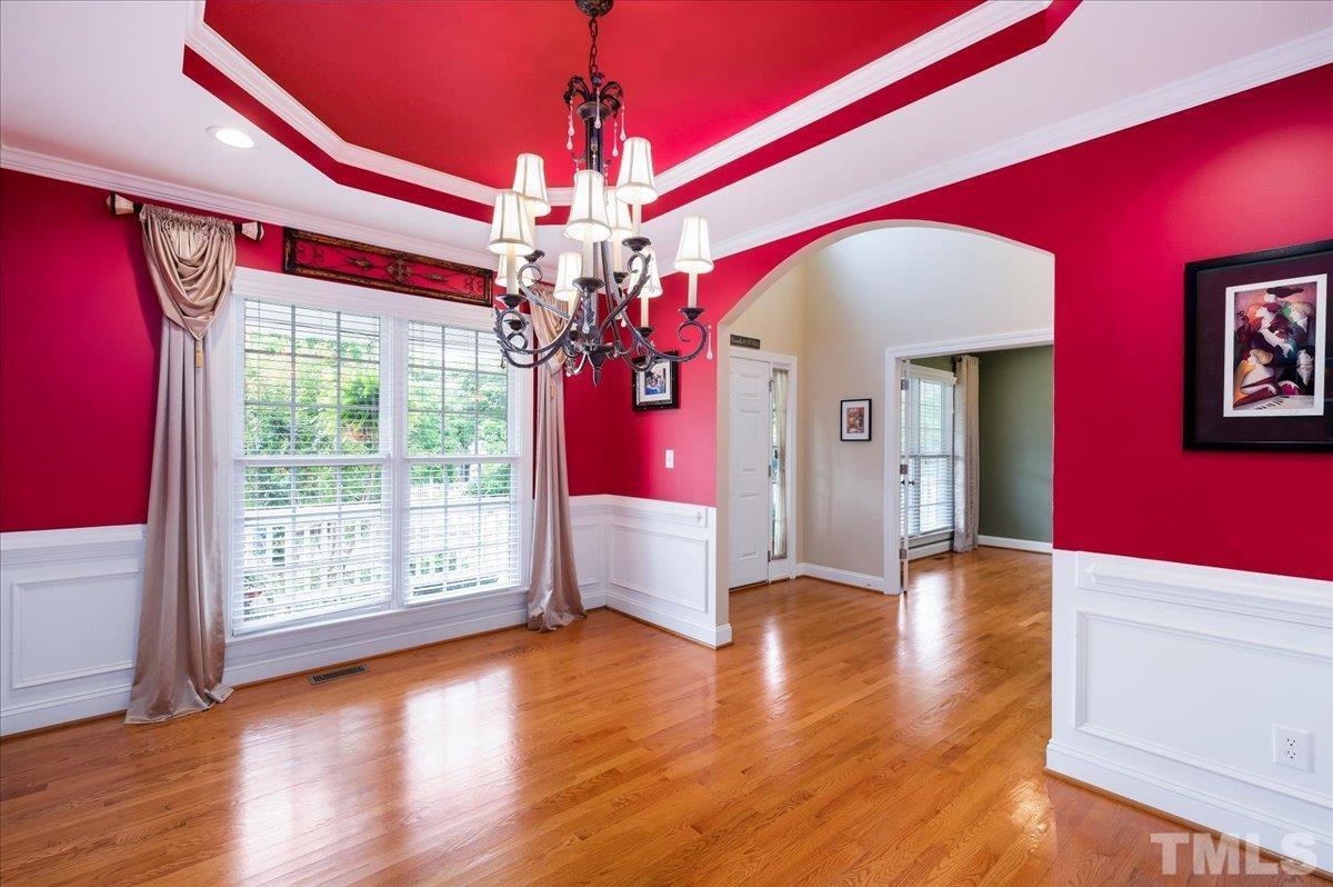 2624 Falls River Avenue Raleigh, NC 27614 - Photo 8 of 38 a view of a livingroom with hardwood floor and chandelier