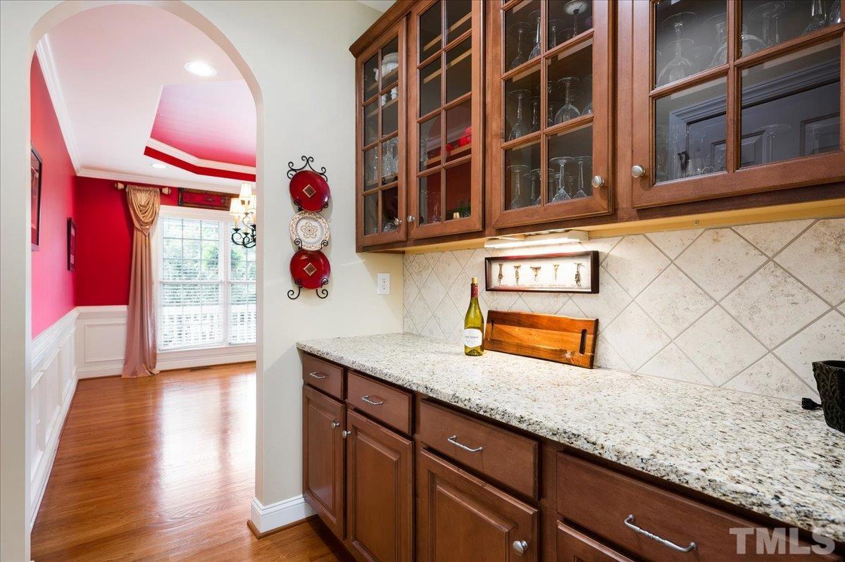 2624 Falls River Avenue Raleigh, NC 27614 - Photo 9 of 38 a kitchen with stainless steel appliances granite countertop a sink and a granite counter tops with wooden floors