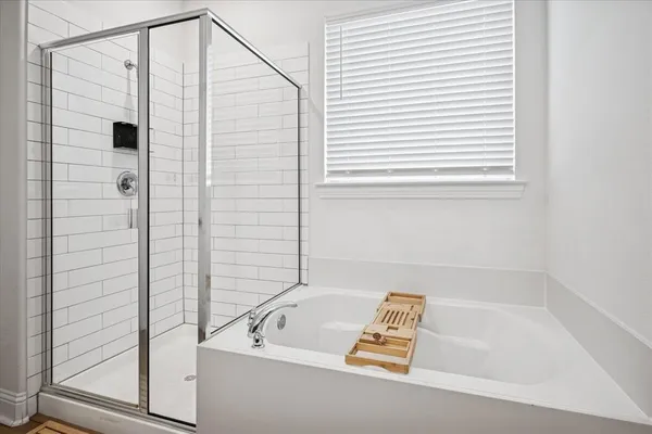 a bathroom with a bath tub and a window