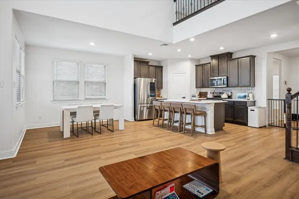 a living room with stainless steel appliances kitchen island granite countertop furniture and a kitchen view