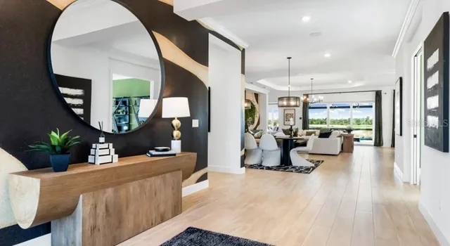 a living room with furniture and a mirror