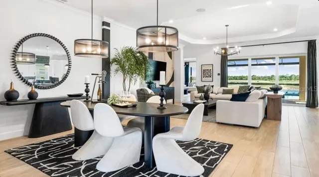 a living room with furniture a rug and a chandelier