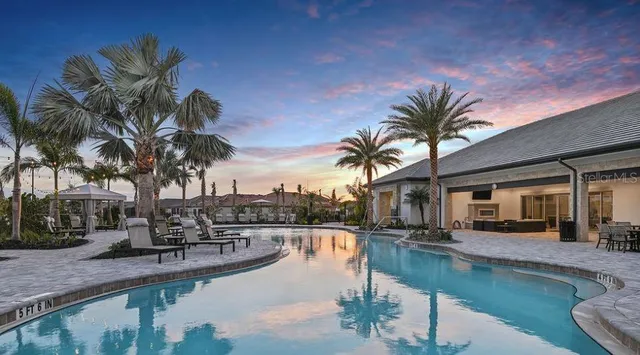 a view of a swimming pool with a table and chairs