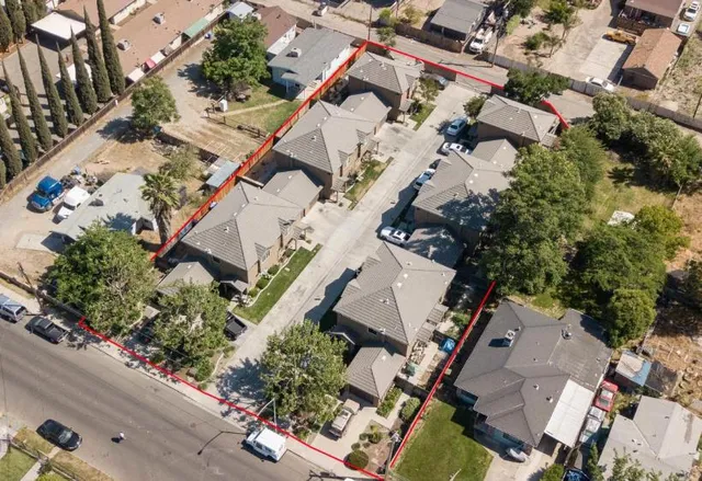 an aerial view of a house with a yard and garden