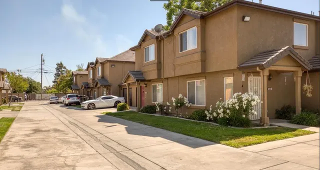 a view of a house with sitting area and garden