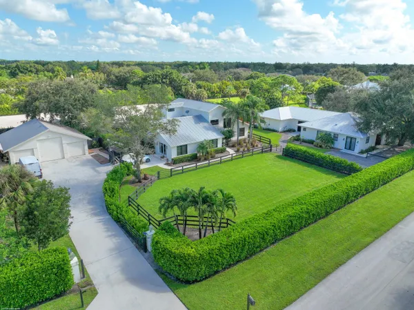 an aerial view of a residential houses with outdoor space and street view