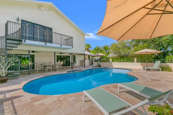 an aerial view of a house with a garden and swimming pool