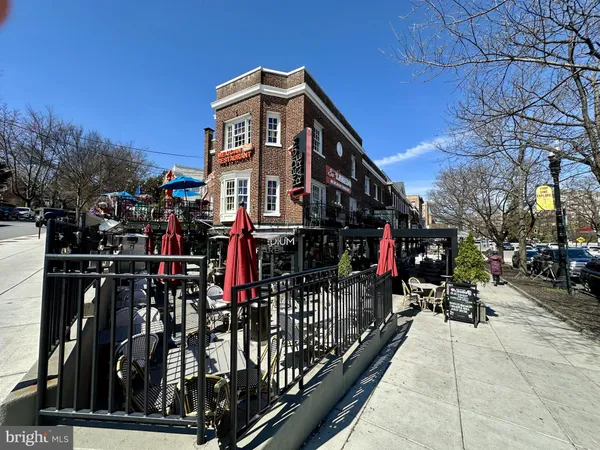 a view of a brick house next to a yard