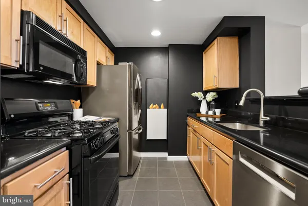 a kitchen with a stove a refrigerator and a microwave