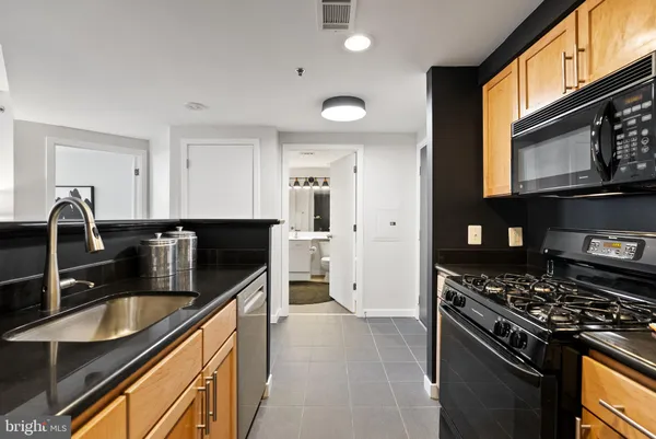 a kitchen with a sink appliances and cabinets