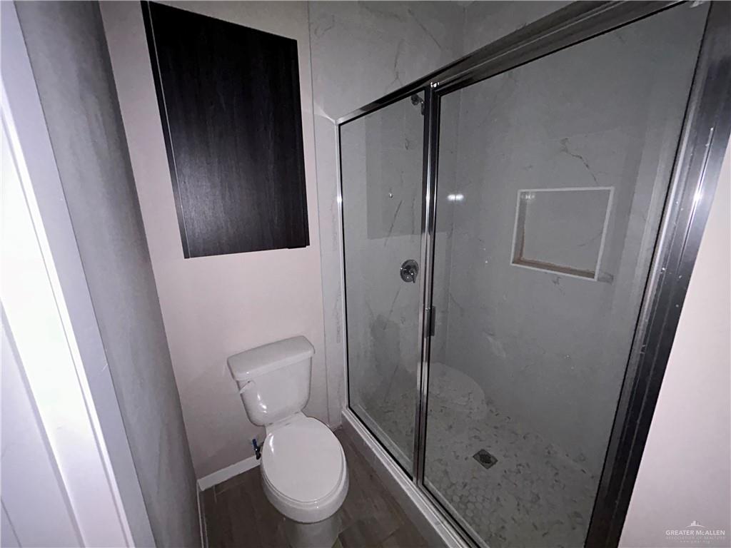 5705 Puffin Avenue, Unit 1 Mission, TX 78573 - Photo 14 of 16 a bathroom with a toilet and a shower