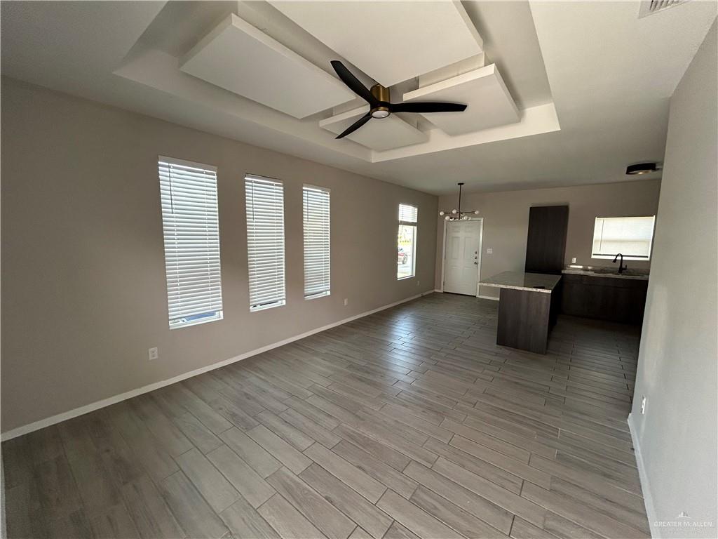 5705 Puffin Avenue, Unit 1 Mission, TX 78573 - Photo 3 of 16 a view of a livingroom with a ceiling fan and wooden floor