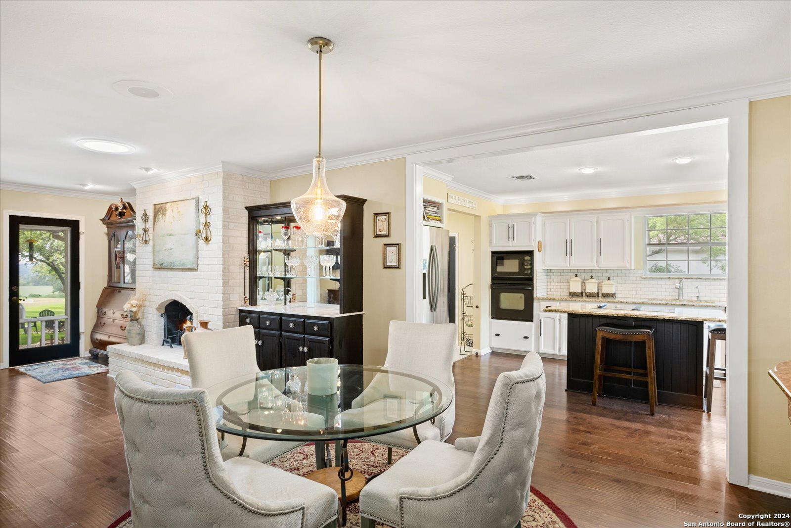 29715 Windchime Hill Fair Oaks Ranch, TX 78015 - Photo 18 of 50 a dining room with furniture a chandelier and fireplace