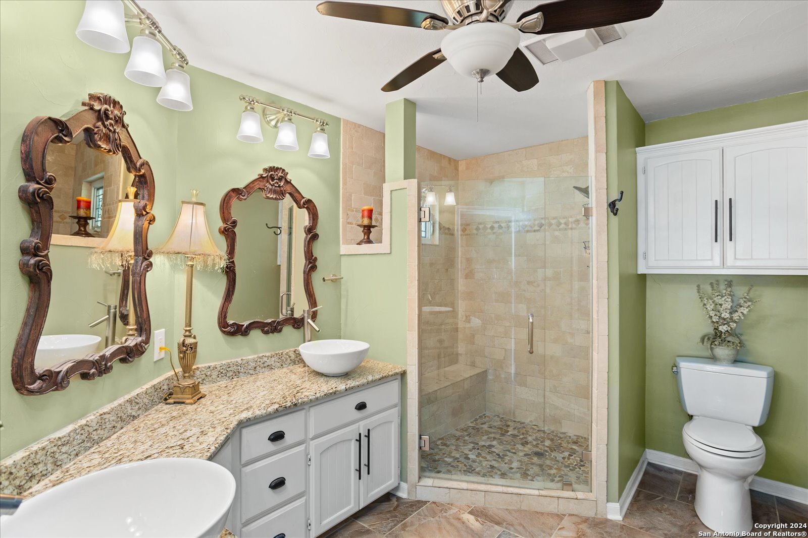 29715 Windchime Hill Fair Oaks Ranch, TX 78015 - Photo 28 of 50 a bathroom with a granite countertop sink a toilet and a mirror