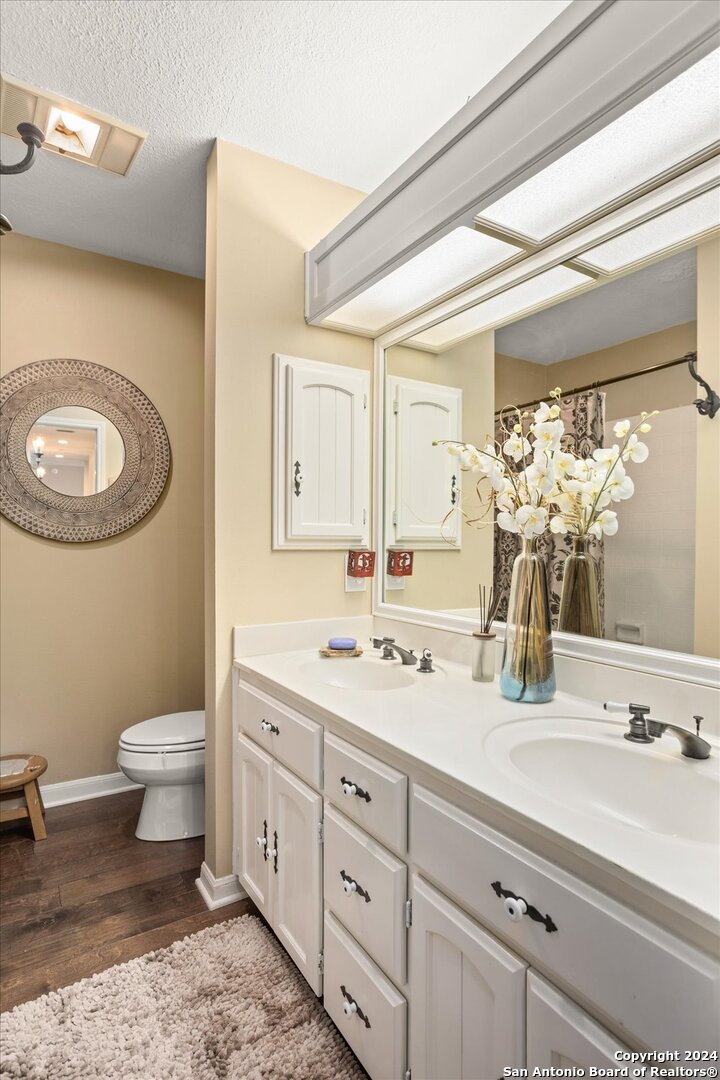 29715 Windchime Hill Fair Oaks Ranch, TX 78015 - Photo 36 of 50 a bathroom with a double vanity sink mirror and toilet