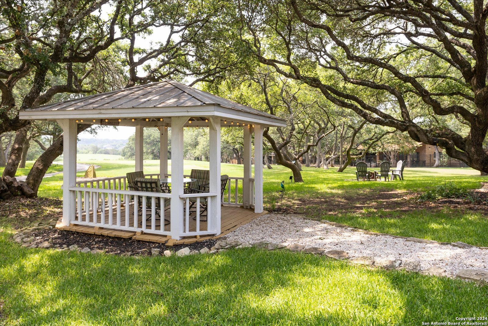 29715 Windchime Hill Fair Oaks Ranch, TX 78015 - Photo 40 of 50 a view of a house with backyard and trees