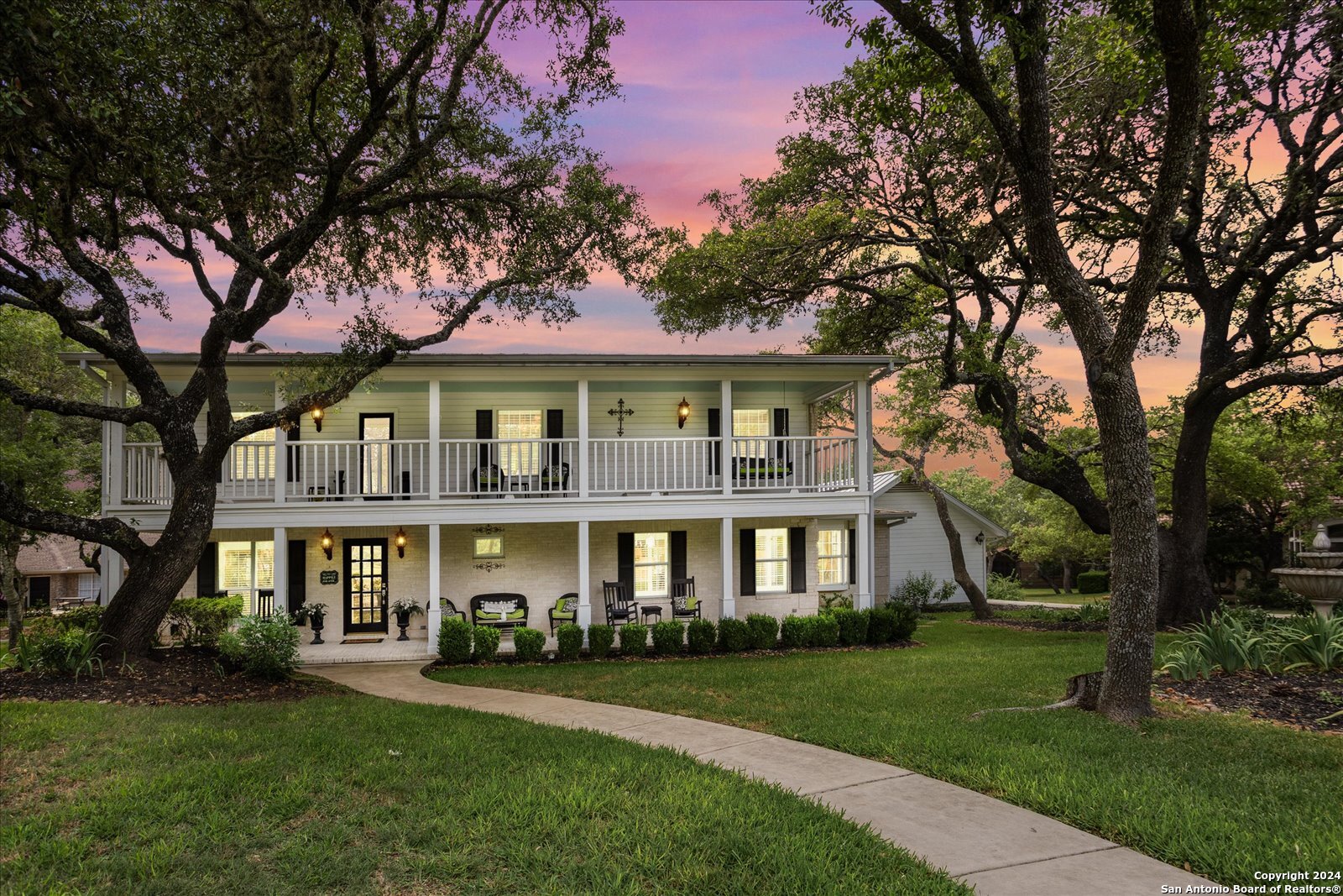 29715 Windchime Hill Fair Oaks Ranch, TX 78015 - Photo 4 of 50 a front view of a residential apartment building with a yard