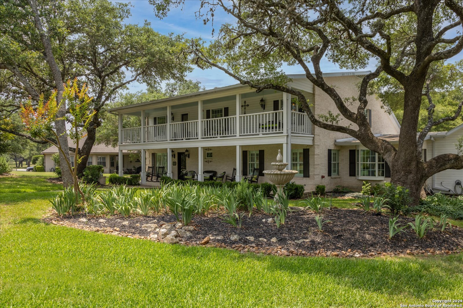 29715 Windchime Hill Fair Oaks Ranch, TX 78015 - Photo 5 of 50 a front view of a house with a garden