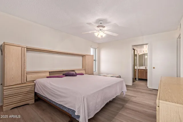 a bedroom with a large bed and a chandelier