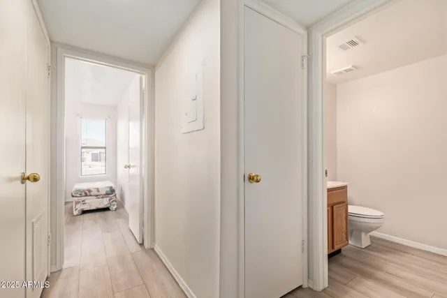 a view of hallway with wooden floor
