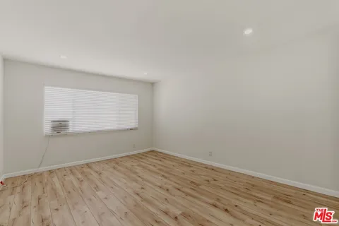 a view of room with wooden floor and fan