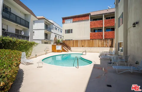 a swimming pool with outdoor seating and yard