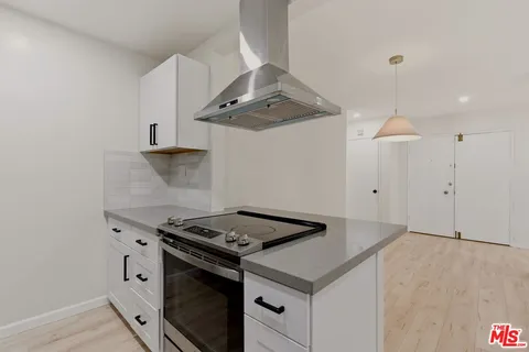 a kitchen with granite countertop a stove and a sink with granite countertops